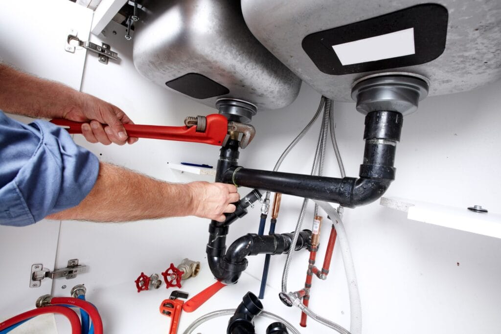 Sarasota Plumbing Pros fixing under sink plumbing and drain pipes