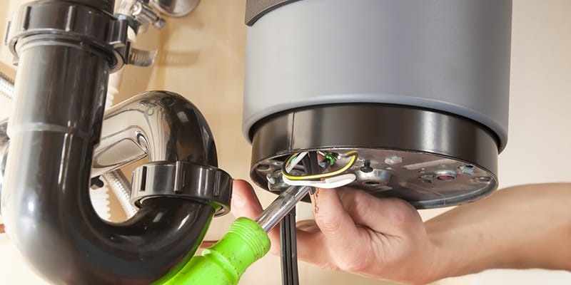 Sarasota, Florida plumber servicing water heater pipe connection